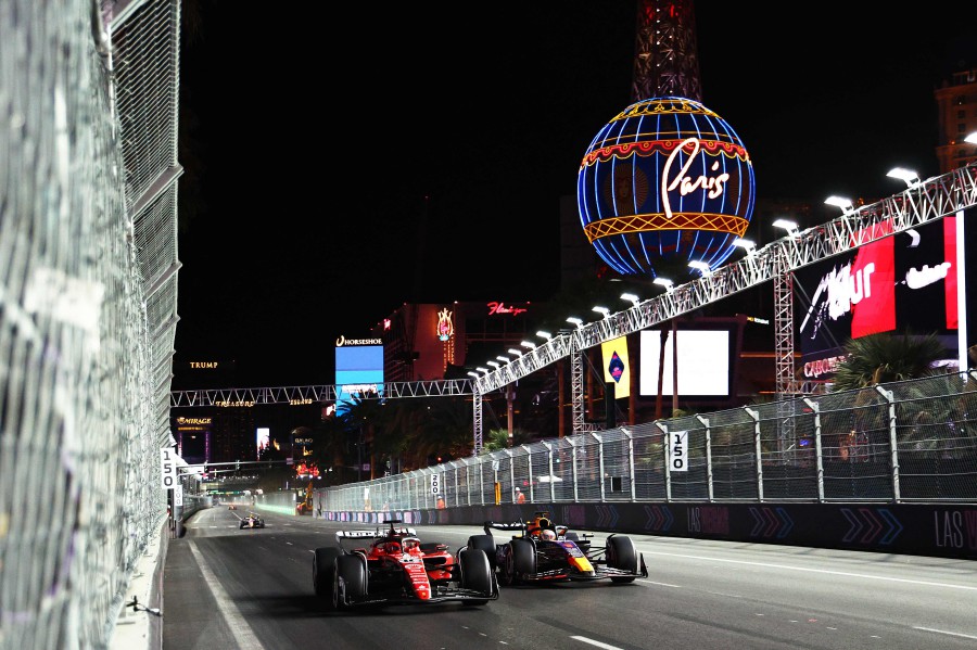 Charles Leclerc of Monaco driving the (16) Ferrari SF-23 and Max Verstappen of the Netherlands driving the (1) Oracle Red Bull Racing RB19 battle for the race lead during the F1 Grand Prix of Las Vegas at Las Vegas Strip Circuit on November 18, 2023 in Las Vegas, Nevada. - AFP pic