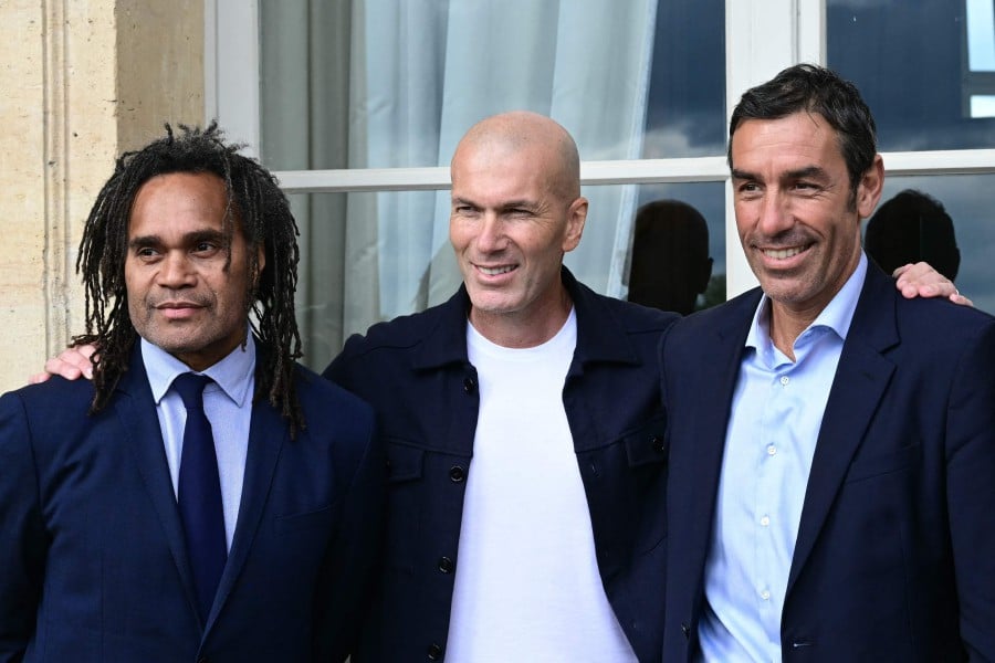 Former players for France's 1998 national football team, Christian Karembeu (L), Zinedine Zidane (C) and Robert Pires (R) pose for photographs ahead of a the gala dinner marking the 15th anniversary of the Diomede Academy, at the Hotel Crillon in Paris, on May 27, 2024. AFP PIC