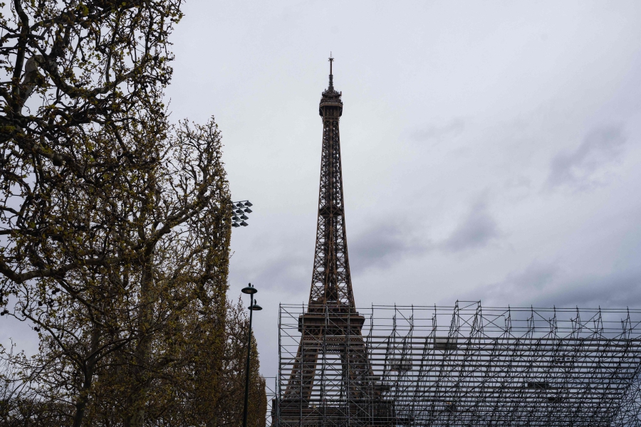 Builders work at the construction site of the Eiffel Tower Stadium’s overlay arena which will host the Beach volleyball tournaments during Paris Olympic Games 2024, at the Champs de Mars near the Eiffel Tower in Paris. (Photo by Dimitar DILKOFF / AFP)