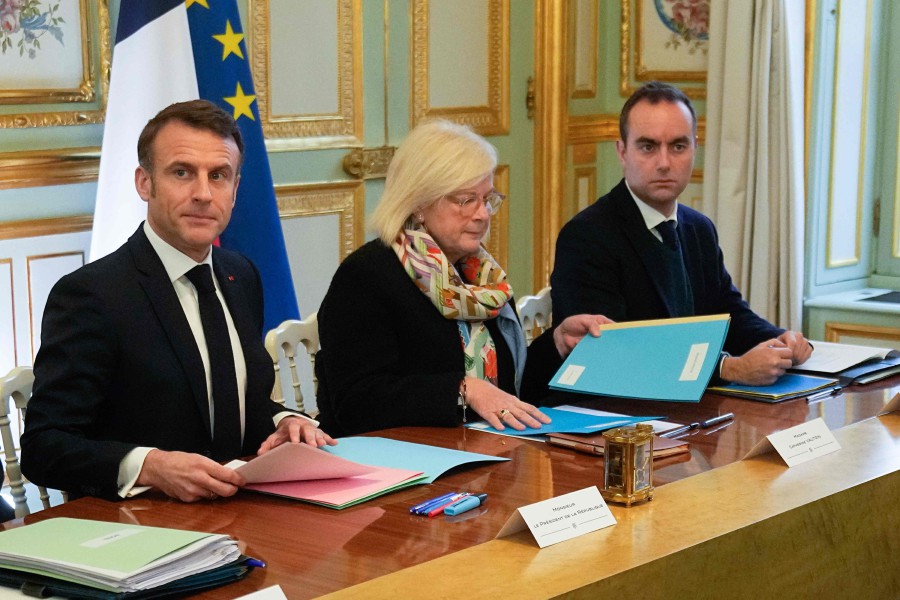 French President Emmanuel Macron (L) sits by French Minister for Labour, Health and Solidarities Catherine Vautrin (C) and French Armies Minister Sebastien Lecornu (R) at the start of the first cabinet meeting following the appointment of a new government the day before, on January 12, 2024 at the Elysee Palace in Paris. AFP PIC