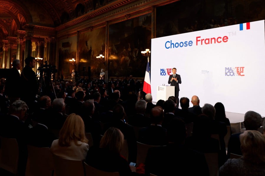  France's President Emmanuel Macron delivers a speech during the seventh "Choose France Summit", aiming to attract foreign investors to the country, at the Chateau de Versailles, outside Paris, on Monday (May 13). France has received combined investment commitments from foreign companies of more than 15 billion euros, the French President's office said today (May 15). — AFP