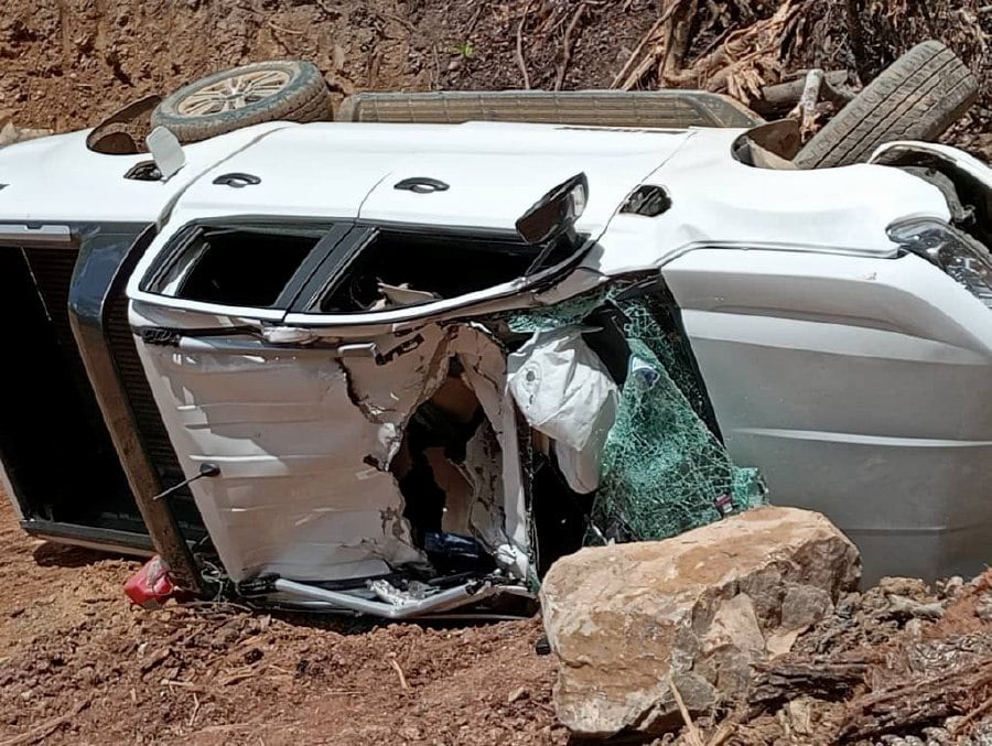 A man tragically lost his life when his vehicle was crushed by a rock that fell from a hill in Kuala Tomani, Mansaam, earlier today. - Pic Cpurtesy of Fire and Rescue Dept