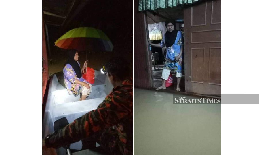 Taman Tas fire and rescue personnel helping a woman leave her flooded house at Kampung Pandan 2 today. - Pix courtesy of Fire and Rescue Dept