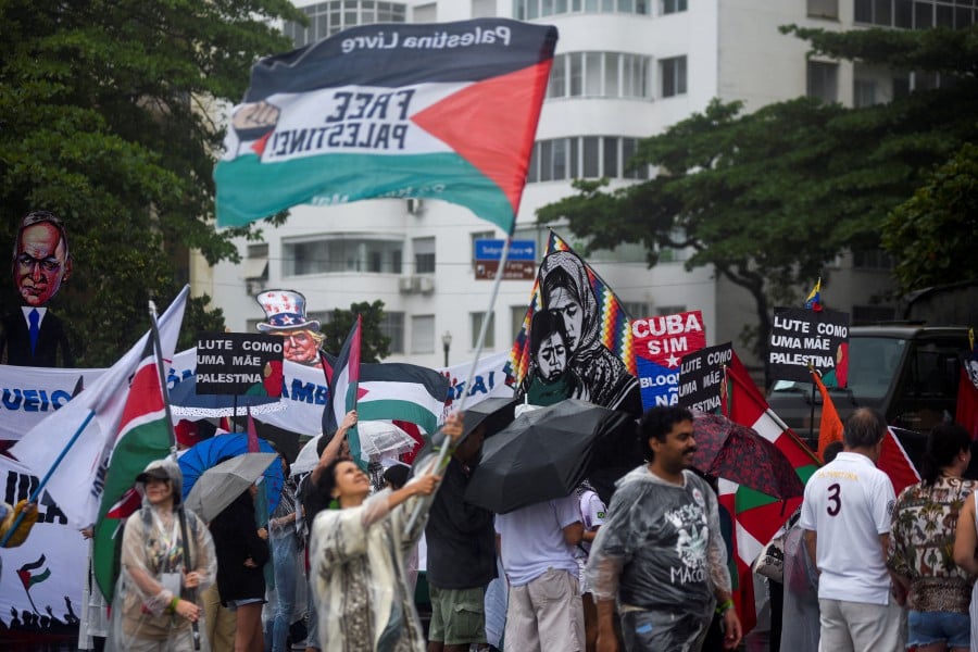 People wave Palestinian flags, during a social movements and unions protest in solidarity with Palestinians in Gaza, amid the Israel-Hamas conflict, ahead of the G20 Summit, in Rio de Janeiro, Brazil. - Reuters  pic