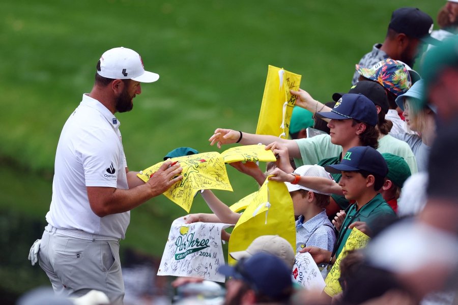 Jon Rahm of Spain signs autographs during the Par Three Contest prior to the 2024 Masters Tournament at Augusta National Golf Club in Augusta, Georgia. (Photo by Maddie Meyer / GETTY IMAGES NORTH AMERICA / Getty Images via AFP)