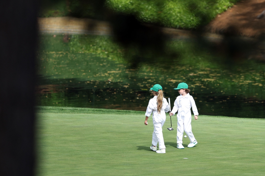 Shane Lowry of Ireland kids walk on the green during the Par Three Contest prior to the 2024 Masters Tournament at Augusta National Golf Club in Augusta, Georgia. (Photo by Warren Little / GETTY IMAGES NORTH AMERICA / Getty Images via AFP)