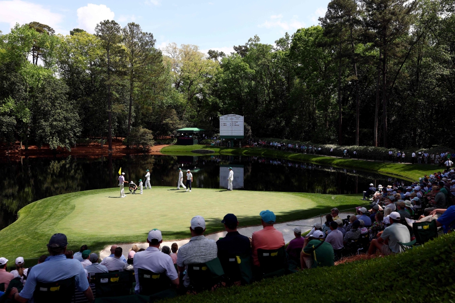 Scottie Scheffler of the United States, Sam Burns of the United States and Tom Kim of South Korea walk on the green during the Par Three Contest prior to the 2024 Masters Tournament at Augusta National Golf Club in Augusta, Georgia. (Photo by Maddie Meyer / GETTY IMAGES NORTH AMERICA / Getty Images via AFP)