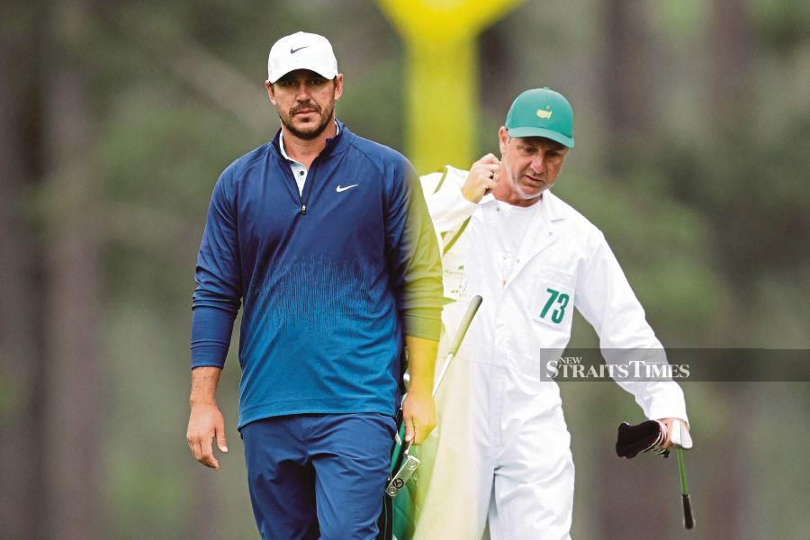 Brooks Koepka of the United States (left) and caddie Ricky Elliott seen on the eighth green during a practice round prior to the 2024 Masters Tournament at Augusta National Golf Club in Augusta, Georgia on Tuesday. AFP PIC 