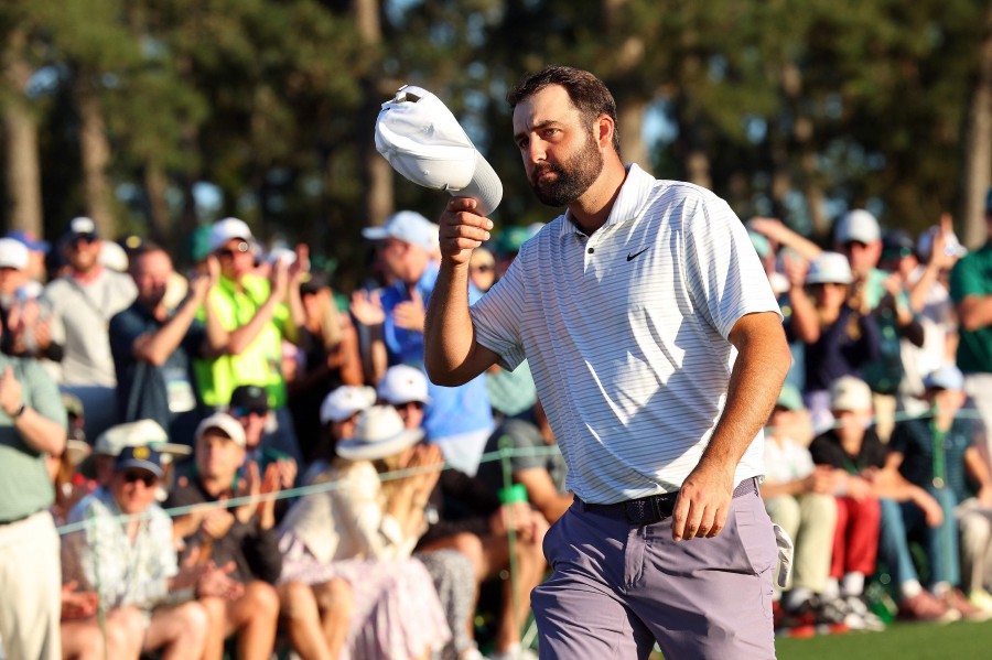 Scottie Scheffler of the United States tips his hat to the crowd on the 18th green after finishing his round during the third round of the 2024 Masters Tournament at Augusta National Golf Club on April 13, 2024 in Augusta, Georgia. AFP PIC