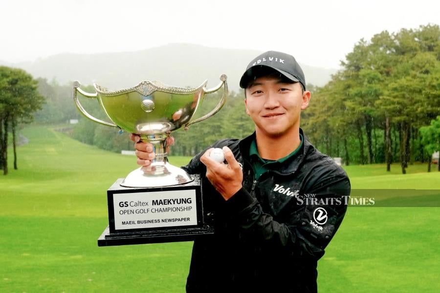 South Korea's Kim Hong-taek posing with the trophy after winning the Asian Tour's GS Caltex Maekyung Open in Seongnam yesterday. AFP PIC