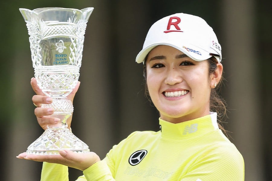 Japan's Mone Inami poses with the trophy after her victory in the final round of the LPGA Japan Classic women's golf tournament on the Minori Course at the Taiheyo Golf Club in Omitama, Ibaraki prefecture . - AFP pic