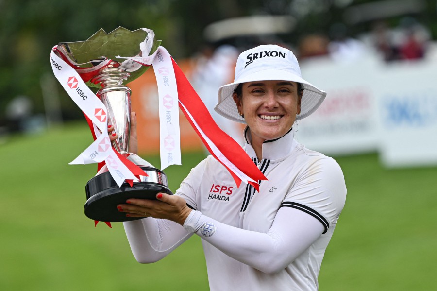 Hannah Green of Australia lifts the trophy after winning the final round of the HSBC Women's World Championship golf tournament at Sentosa Golf Club in Singapore. - AFP pic