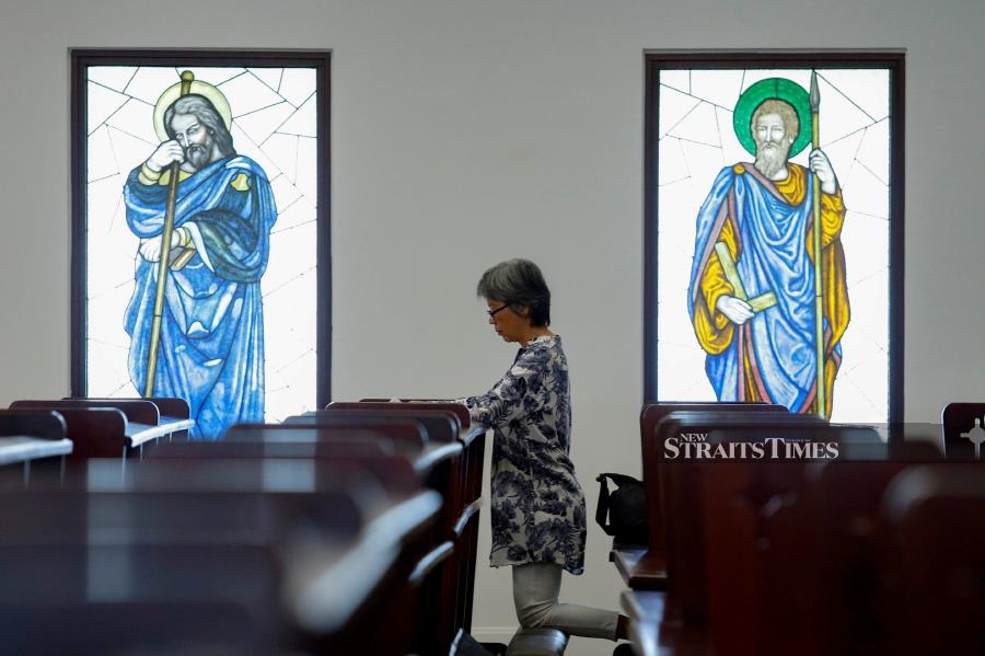 Worshipper pray as she celebrating Good Friday at the St. Francis of Assisi Church in Cheras. Pic by NSTP/AIZUDDIN SAAD