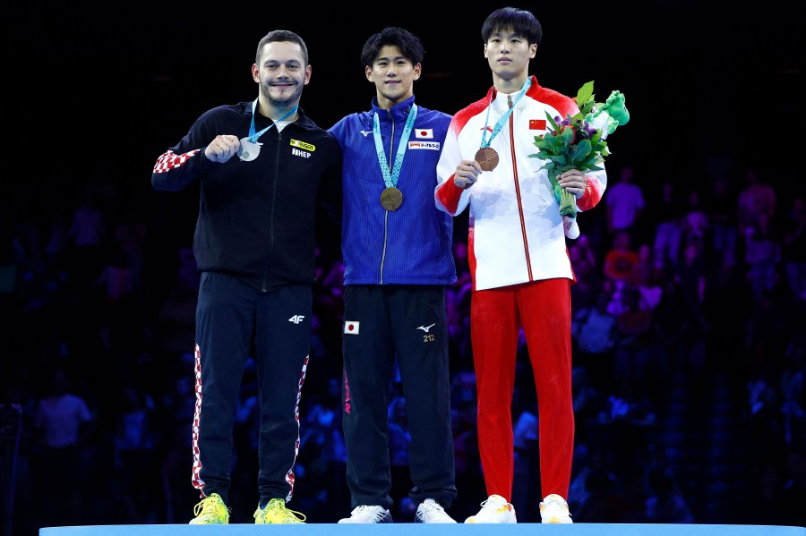 (From L) Second-placed Croatia's Tin Srbic, winner Japan's Daiki Hashimoto and third-placed China's Weide Su celebrate on the podium after the Men's Horizontal Bar Final during the 52nd FIG Artistic Gymnastics World Championships, in Antwerp, northern Belgium, on October 8, 2023. AFP PIC