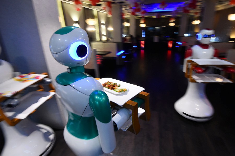 In this picture taken on October 26, 2018, Nepali-made robot waiters deliver food to customers at Naulo restaurant in Kathmandu. - "Please enjoy your meal," says Nepal's first robot waiter, Ginger, as she delivers a plate of steaming dumplings to a table of hungry customers. The poor Himalayan nation is better known for its soaring mountain peaks than technological prowess, but a group of self-taught young innovators are seeking to change that. AFP 