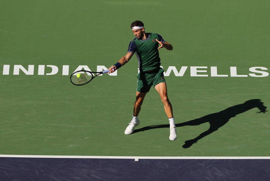 Grigor Dimitrov of Bulgaria plays a forehand against Hubert Hurkacz of Poland during their quarterfinal match on Day 11 of the BNP Paribas Open at the Indian Wells Tennis Garden on October 14, 2021 in Indian Wells, California. - AFP PIC