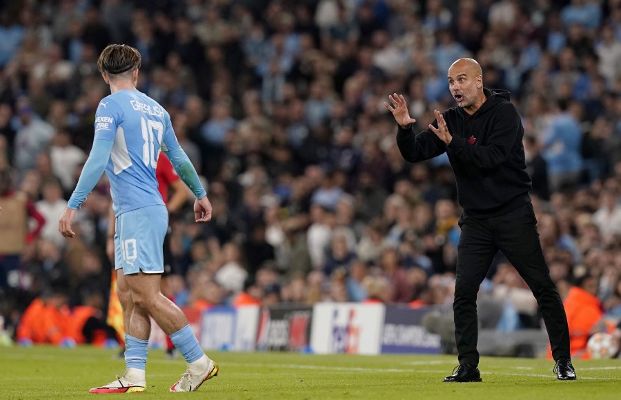 Manchester City's manager Pep Guardiola (R) gives instructions to Jack Grealish (L) during the UEFA Champions League match against RB Leipzig in Manchester, Britain. - EPA PIC