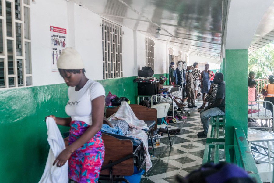 Injured patients rest at a hospital in Les Cayes on August 15, 2021, after a 7.2-magnitude earthquake struck the southwest peninsula of the country. - Hunched on benches, curled up in chairs or even lying the floor, those injured in the powerful earthquake that wreaked havoc on Haiti on Saturday crowded an overburdened hospital near the epicenter. The emergency room in Les Cayes, in southwestern Haiti, which was devastated by the 7.2-magnitude quake on Saturday morning that killed at least 724 people, is expecting reinforcements to help treat some of the thousands of injured. (Photo by Reginald LOUISSAINT JR / AFP)