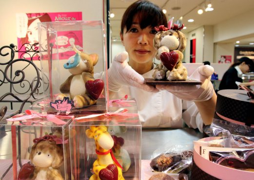 Japanese chocolatier Miya Fujimoto of sweet shop Etienne displays animal-shaped chocolates at the Takashimaya department store's large chocolate event "Amour du Chocolat" for the upcoming St. Valentine's Day in Tokyo on February 4, 2015. Fujimoto produced two life sized cartoon character chocolate statues, made of 300kg chocolate at the entrance of the department store. AFP PHOTO / Yoshikazu TSUNO