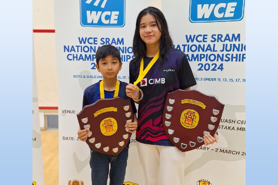 Hisshan Nair and his sister, Harleein Tan, posing with their National Junior Squash Championships trophies today. 