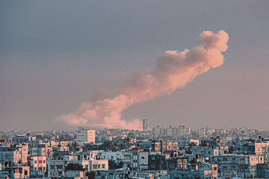 A picture taken from Rafah in the southern Gaza Strip shows smoke rising over buildings in Khan Yunis following Israeli bombardment on February 5, 2024. - AFP pic
