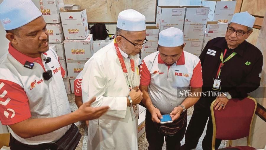 Tabung Haji (TH) external services manager Zahari Zainal (right) said the trend of delivery of goods was similar to last year where pilgrims liked to send goods purchased earlier despite the differences in currency exchange. - NSTP/Husain Jahit