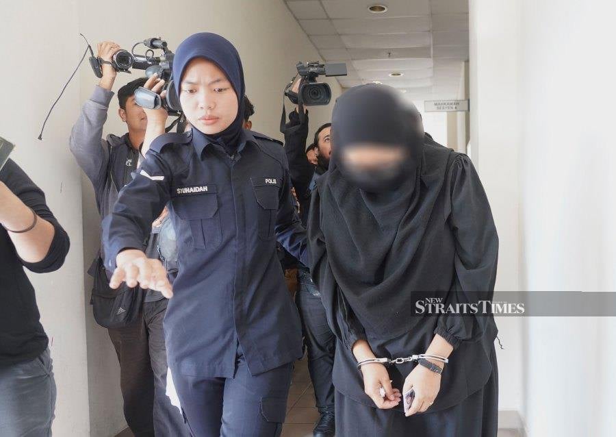 Nur Sri Fardiana Mohd Amran, 38, who was dressed in a black jubah, listened attentively when the charge was read out to her before Sessions Court Judge Dr Syahliza Warnoh. - NSTP/MOHAMAD SHAHRIL BADRI SAALI