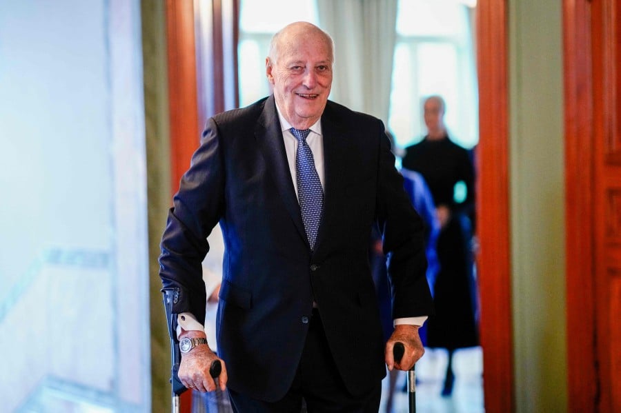 King Harald V of Norway walks on crutches on his way to lunch with members the Norwegian government, on Feb 24 in Oslo, Norway. King Harald, 87, has been hospitalised with an infection while on a holiday here in Malaysia, the Royal House of Norway said yesterday (Feb 27). — AFP