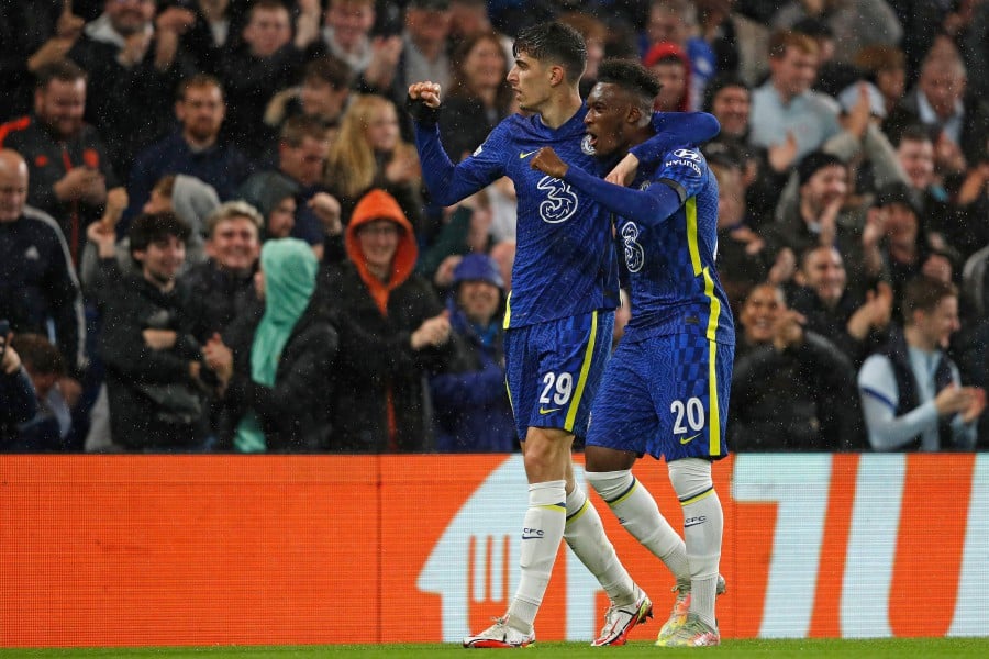 Chelsea's German midfielder Kai Havertz celebrates scoring his team's third goal with Chelsea's English midfielder Callum Hudson-Odoi during the Champions League group H football match between Chelsea and Malmo FF at Stamford Bridge in London. - AFP PIC