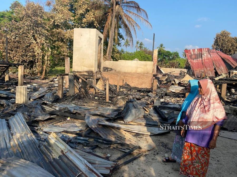 The family of Rosniza Yusoff, 45, and her 49-year-old sister, Rosnani, who were living next to each other in the same village, were left with only clothes on their backs when the fire broke out around noon. STR/HAZIRA AHMAD ZAIDI
