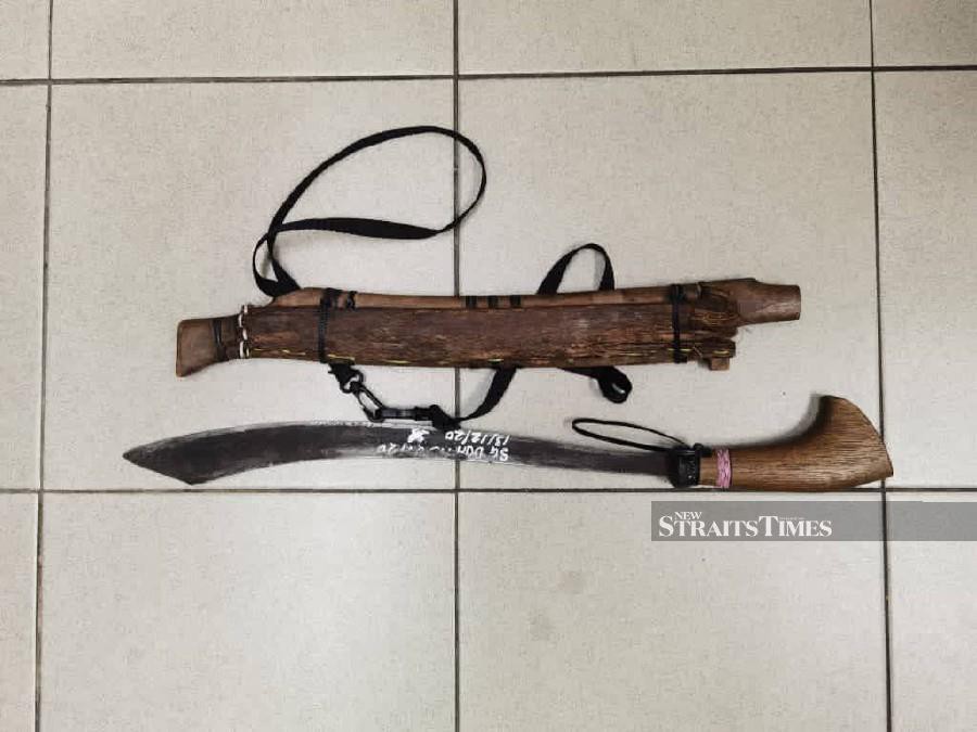 A man high on drugs barricaded himself and his family inside a room, while wielding a 54-centimetre machete at Jalan Pokok Sena, on Saturday night. - NSTP/ Courtesy of PDRM