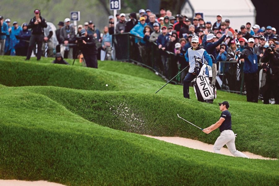 Viktor Hovland of Norway plays a shot from a bunker on the 18th hole during the third round of the 2023 PGA Championship at Oak Hill Country Club on May 20, 2023 in Rochester, New York.-AFP PIC