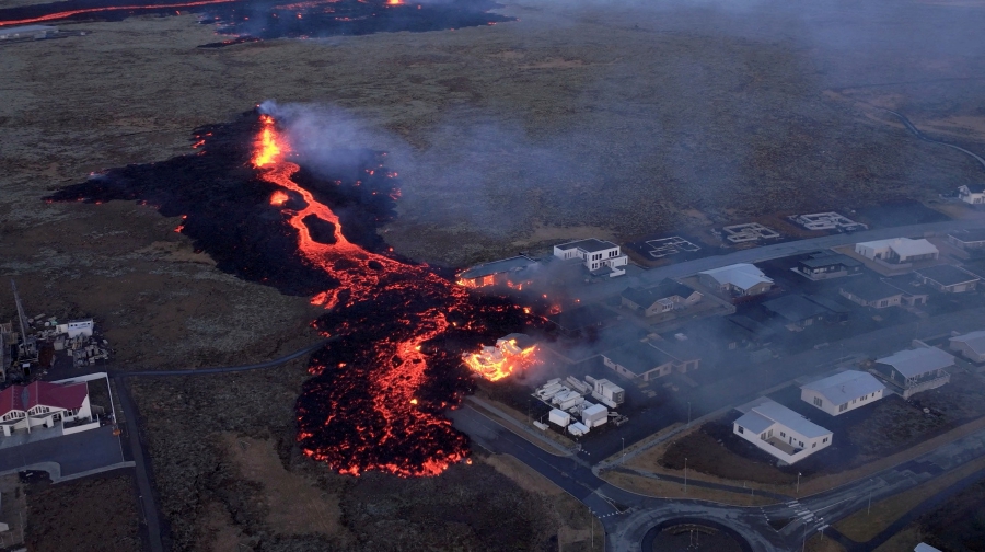 Lava flows from a volcano as houses burn in Grindavik, Iceland. (Bjorn Steinbekk/@bsteinbekk via Instagram/via REUTERS)