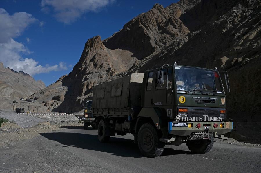 A military convoy drives towards Leh along the Srinagar-Leh Highway. (Photo by TAUSEEF MUSTAFA / AFP)