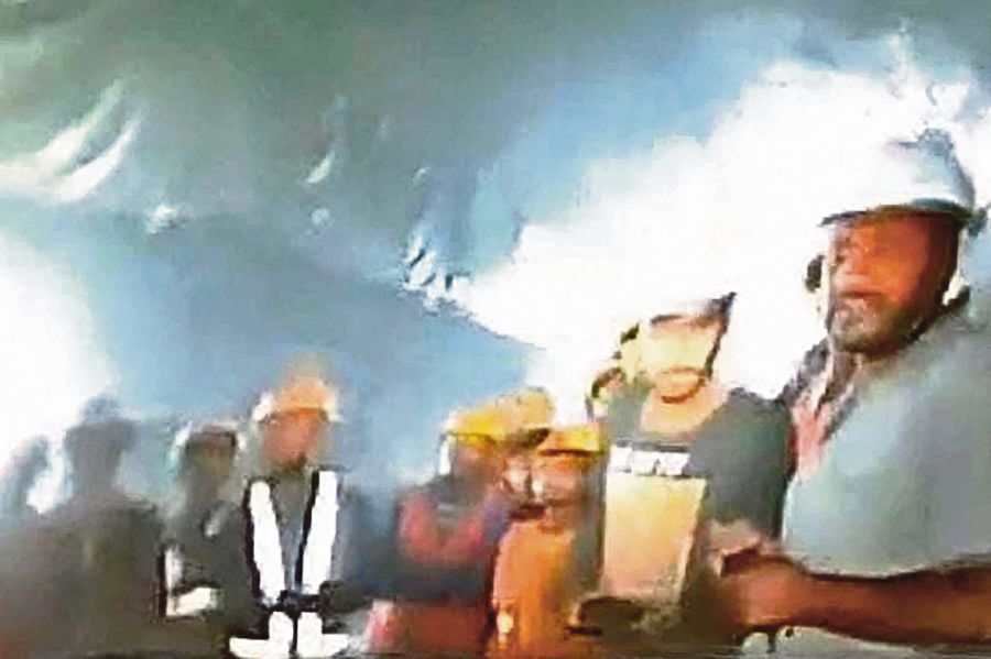 Forty-one Indian workers trapped in a collapsed road tunnel for 10 days were seen alive on camera for the first time November 21 as workers attempted to create new passageways to free them. (Photo by Department of Information and Public Relation (DIPR) Uttarakhand / AFP) 