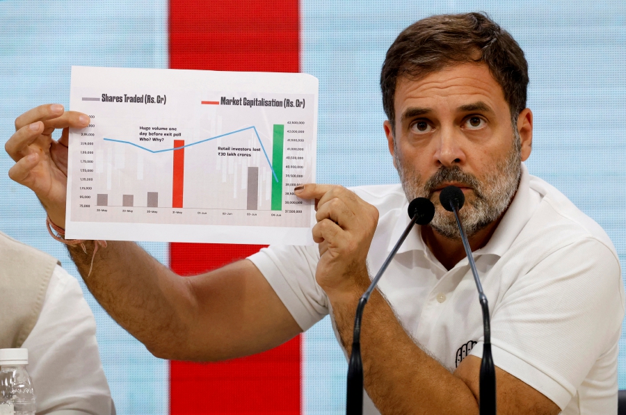 Rahul Gandhi, a senior leader of Congress party, shows a paper as he speaks during a media briefing at the party headquarters in New Delhi, India. (REUTERS/Priyanshu Singh)