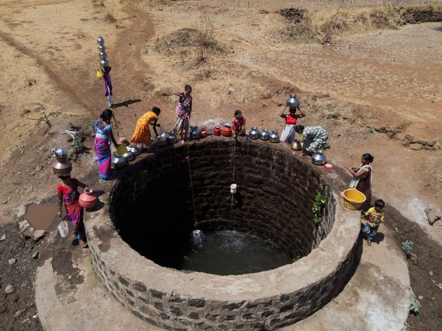 A drone view of women drawing water from a well on a hot day in Kasara, India. (REUTERS/Francis Mascarenhas)