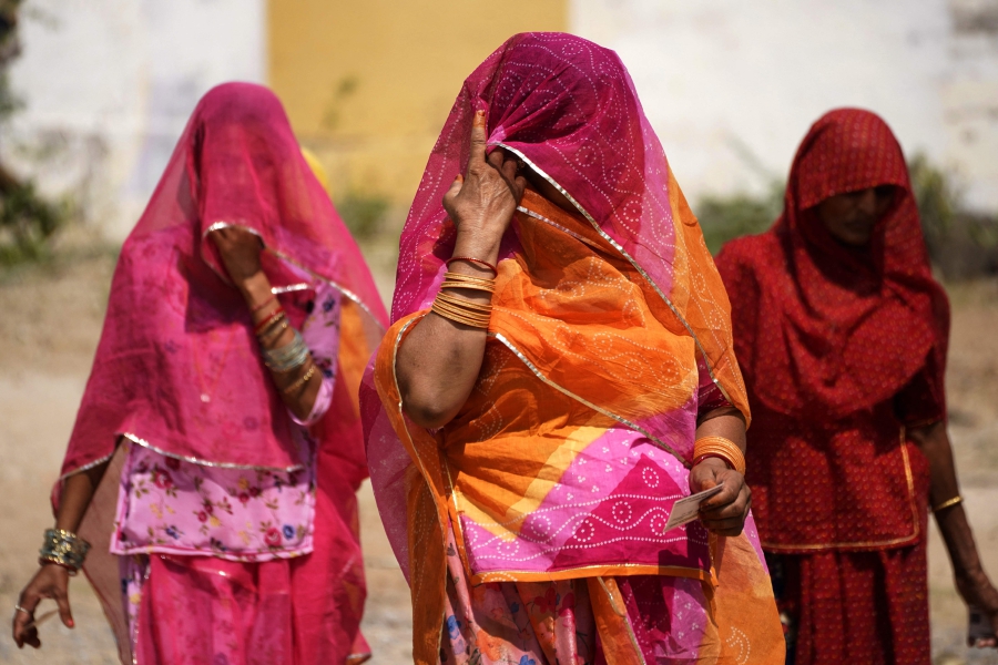 Women leave after casting their votes at a polling station during the second phase of voting of India's general election in Ajmer. (Photo by Himanshu SHARMA / AFP)