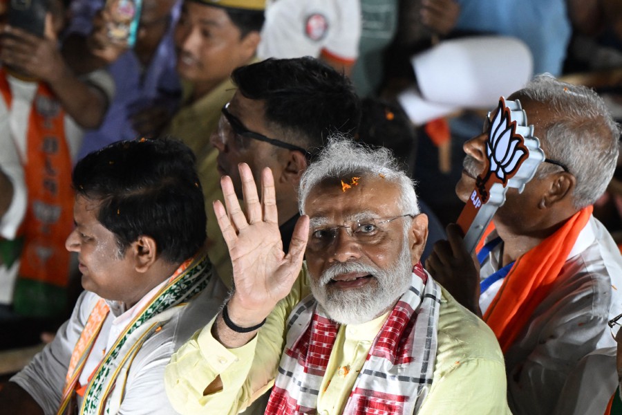 India's Prime Minister and leader of ruling Bharatiya Janata Party (BJP) Narendra Modi (C) greets his supporters during an election campaign rally, in Kolkata on May 28, 2024, ahead of the seventh and final phase of voting in country's general election. AFP