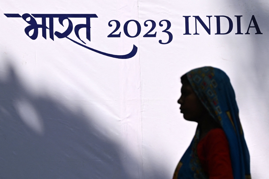 A pedestrian walks past a billboard along a street in New Delhi. India's opposition condemned rumoured plans to scrap offical usage of the country's English name, in what could be the largest government effort yet to shed colonial-era nomenclature. (Photo by Sajjad HUSSAIN / AFP)