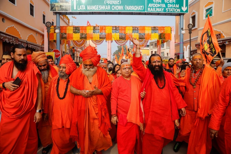 Hindu holy men walk during a procession as they arrive, on the eve of opening of the temple of Hindu Lord Ram in Ayodhya, in India. (REUTERS/Adnan Abidi)