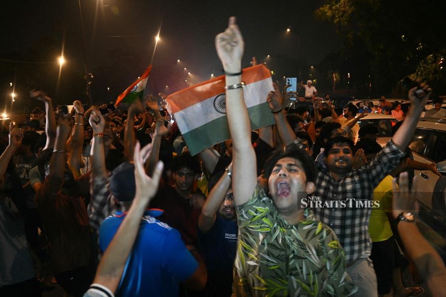 Fans celebrate India's victory at the ICC men's Twenty20 World Cup, at India gate in New Delhi on Sunday. AFP PIC