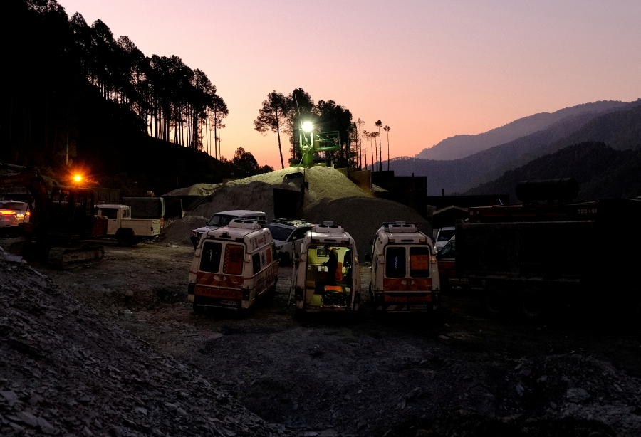 Ambulances are parked outside a tunnel where workers are trapped after the tunnel collapsed in Uttarkashi in the northern state of Uttarakhand, India. (REUTERS/Shankar Prasad Nautiyal)