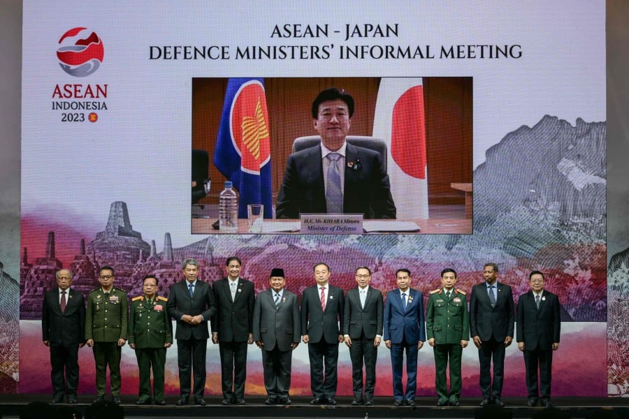 Japan's Defence Minister Minoru Kihara (on screen) participates online with Indonesia's Defence Minister Prabowo Subianto (6th L), Japan's State Minister of Defence Hiroyuki Miyazawa (6th R) and other ministers for a family photo during the ASEAN-Japan Defence Ministers' Informal Meeting in Jakarta on November 15, 2023. AFP PIC