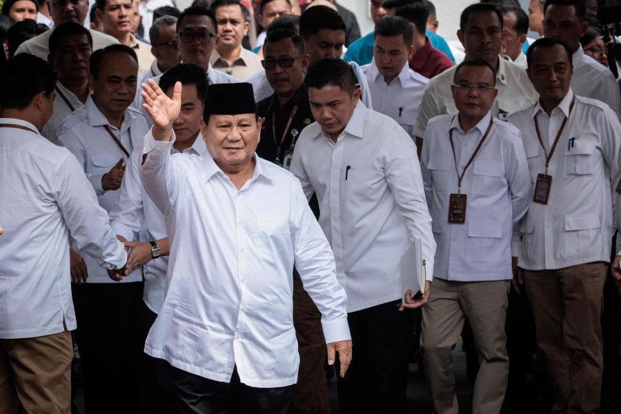 Indonesia's president-elect Prabowo Subianto gestures to the media as he arrives at the plenary session of the General Elections Commission (KPU) after his main rivals' challenges to his election victory were rejected at the KPU office in Jakarta. (Photo by Yasuyoshi CHIBA / AFP)
