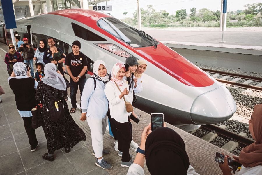 People take pictures with the first car of the Jakarta-Bandung high-speed train during a week-long public trial phase at the Tegalluar station in Bandung, West Java, on September 17, 2023. - AFP pic
