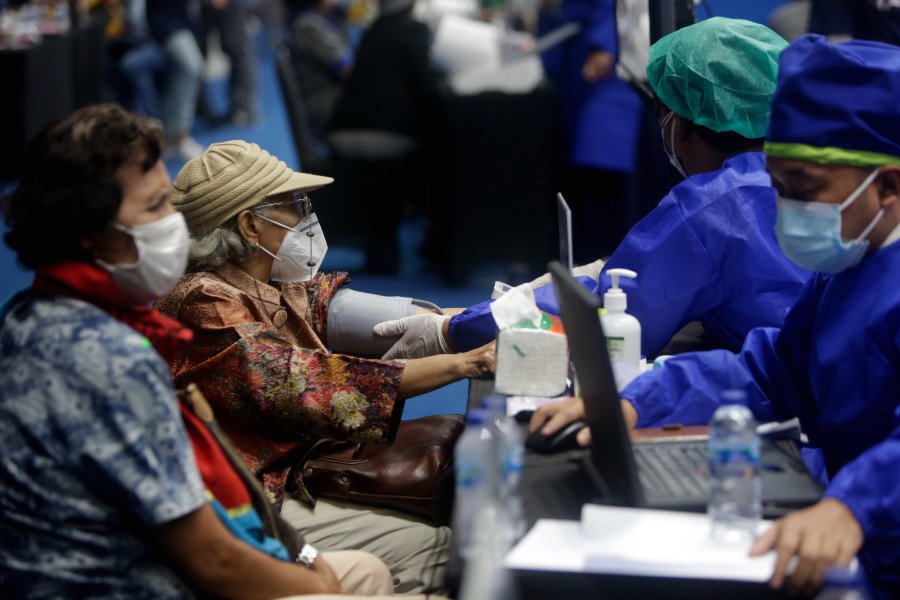 Elderly women are examined by doctors before receiving a shot of Covid-19 vaccine during a mass vaccination drive in Jakarta, Indonesia. - EPA pic