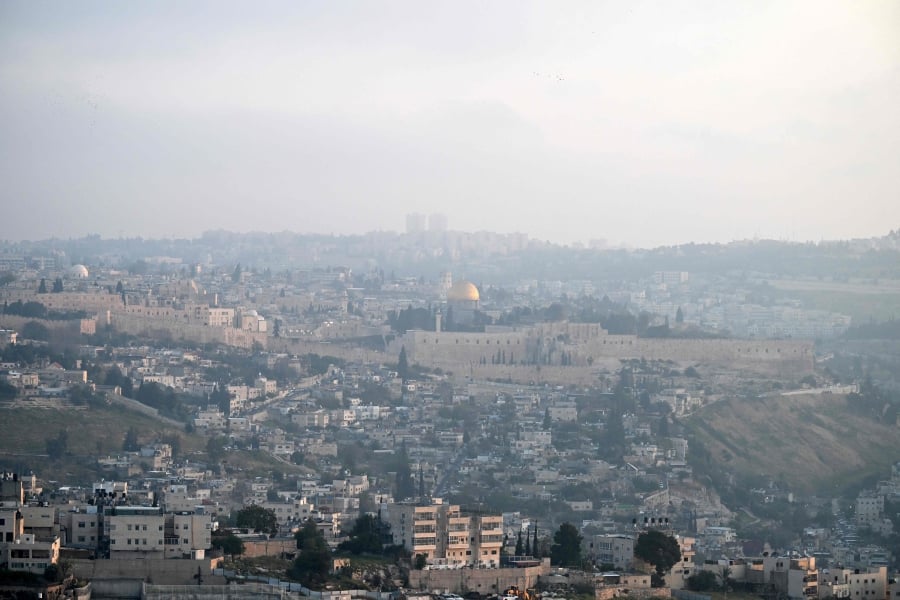 A panoramic view of Jerusalem's Old City is pictured at dawn, after Iran launched a drone and missile attack on Israel. (Photo by RONALDO SCHEMIDT / AFP)