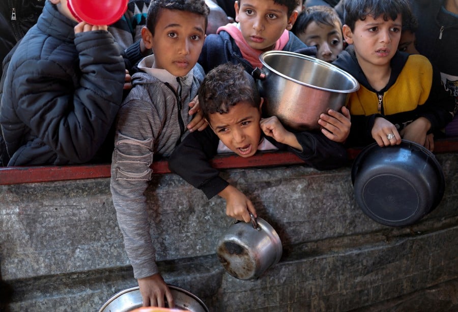 Palestinian children wait to receive food cooked by a charity kitchen amid shortages of food supplies, as the ongoing conflict between Israel and the Palestinian Islamist group Hamas continues, in Rafah, in the southern Gaza Strip, February 5, 2024. REUTERS PIC