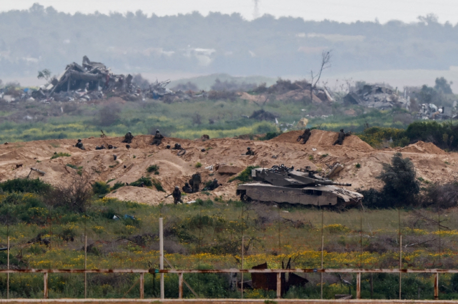 Israeli soldiers operate inside Gaza, amid the ongoing conflict between Israel and the Palestinian group Hamas, as seen from southern Israel. (REUTERS/Amir Cohen)